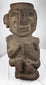 Ancient Mezcala-style stone effigy with geometric head, elongated nose, and compact seated form