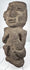 Pre-Columbian volcanic stone figure with recessed eyes, prominent brow, and stylized facial features