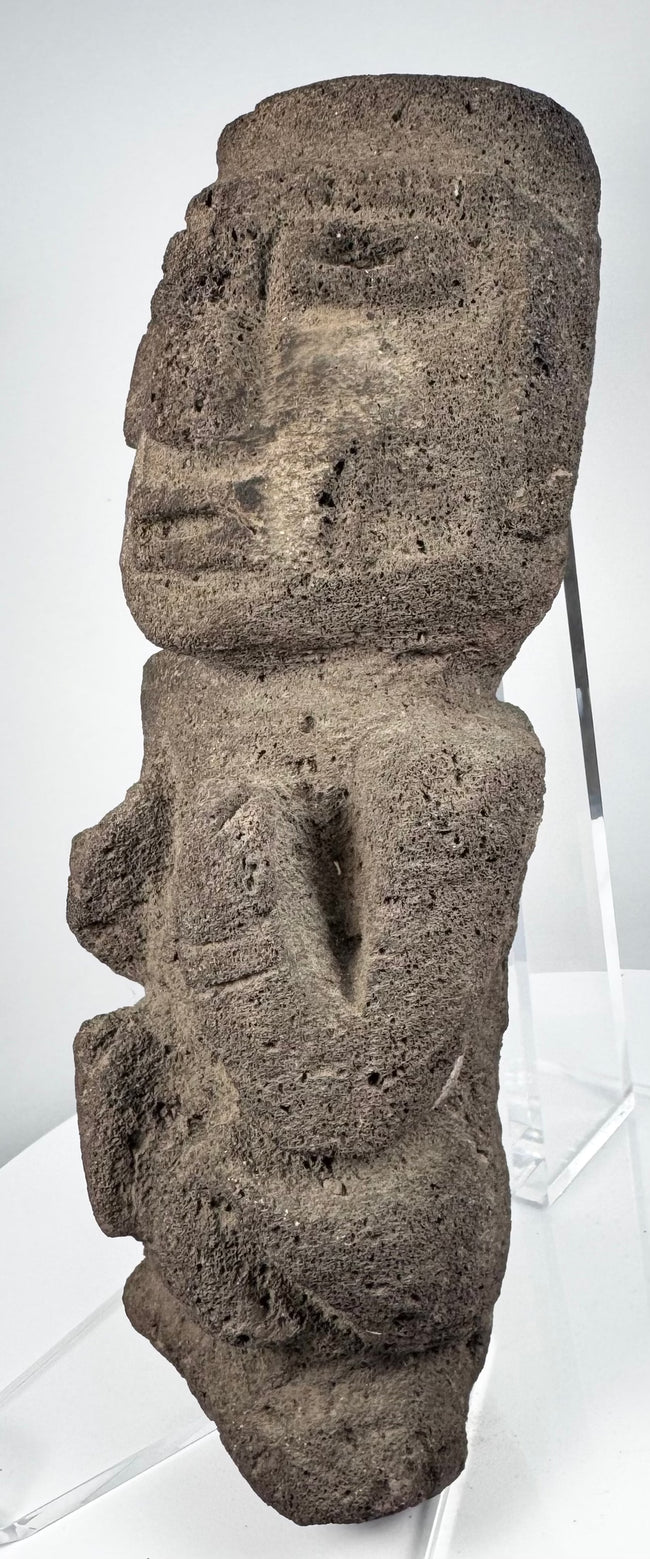 Ancient Mesoamerican stone effigy with oversized rectangular head and weathered porous surface