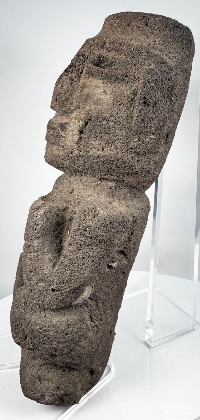 Guerrero stone sculpture depicting an abstract human figure with bent arms and flexed legs