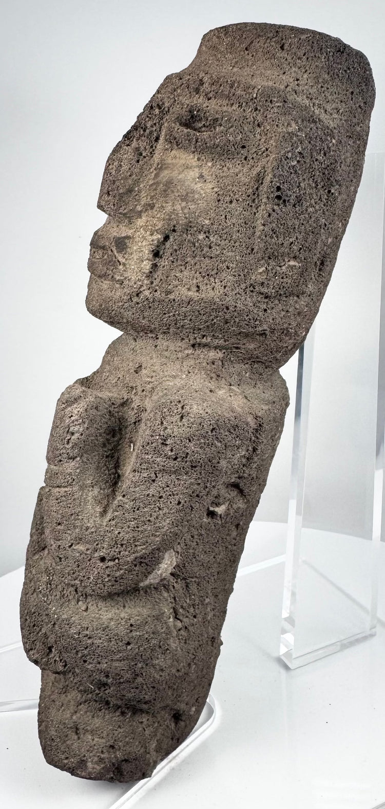 Guerrero stone sculpture depicting an abstract human figure with bent arms and flexed legs