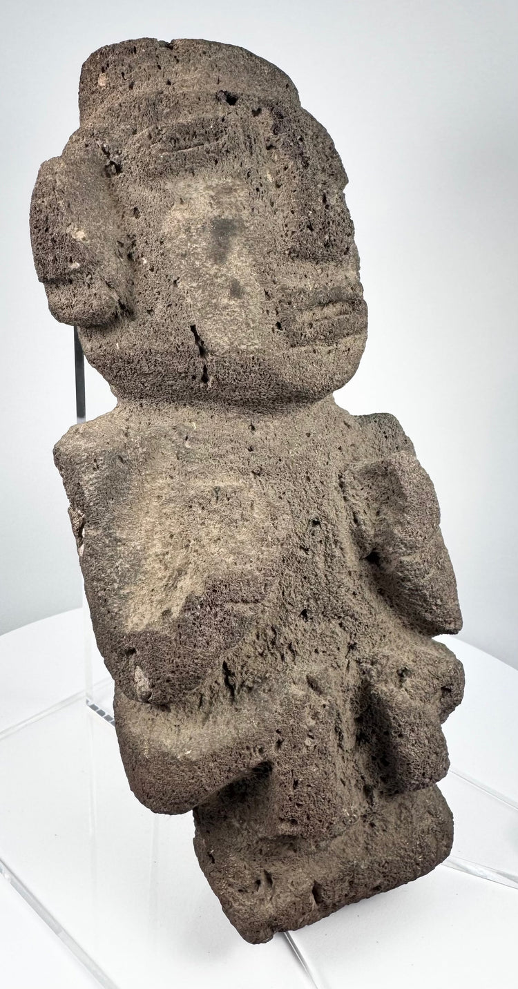 Ancient Mexican stone sculpture with projecting nose, lateral ear forms, and compact body