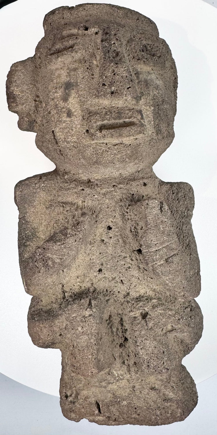 Ancient Guerrero stone figure highlighting carved facial details and textured archaeological surface