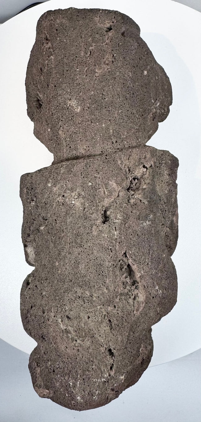 Back view of Pre-Columbian Guerrero stone figure showing flattened reverse and natural volcanic stone texture