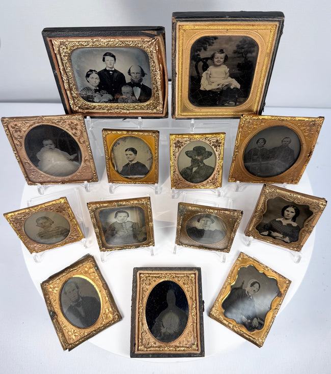 Antique ambrotype and tintype-style portrait collection with decorative gilt-metal mats and preservers