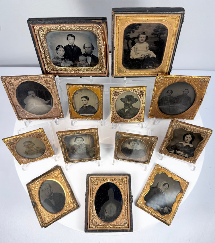 Antique ambrotype and tintype-style portrait collection with decorative gilt-metal mats and preservers