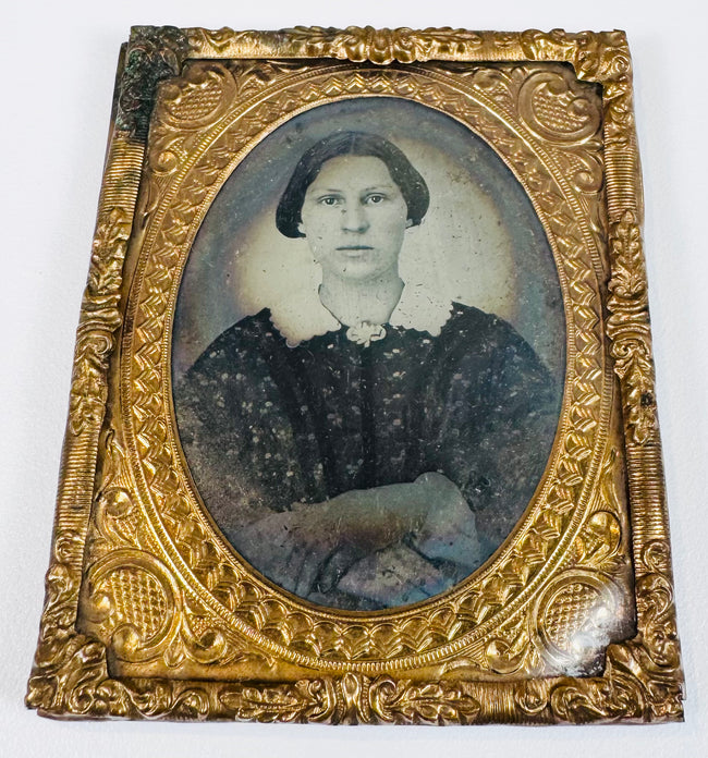 Antique cased portrait of a Victorian woman with period dress and ornate embossed gilt-brass framing
