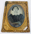 Antique cased portrait of a Victorian woman with period dress and ornate embossed gilt-brass framing