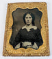 Victorian cased portrait of a woman in a patterned dress with ornate gilt-brass decorative mat