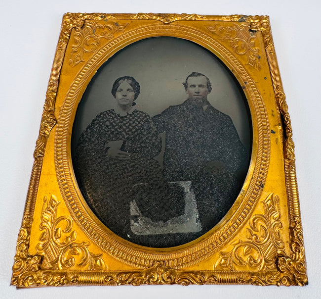 Antique Victorian portrait photograph preserved beneath an ornate embossed gilt-brass mat