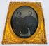 Antique Victorian portrait photograph preserved beneath an ornate embossed gilt-brass mat