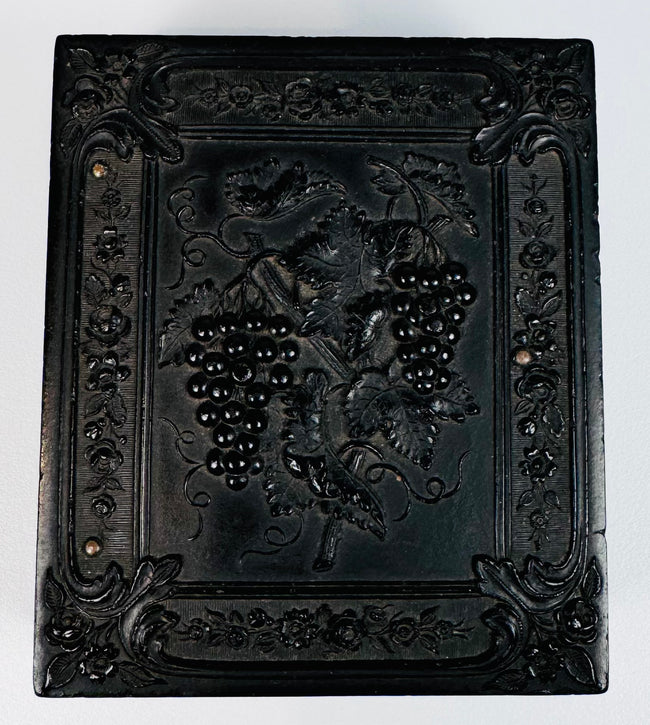 Ornately molded thermoplastic Union case with grapevine, floral, and scroll decoration