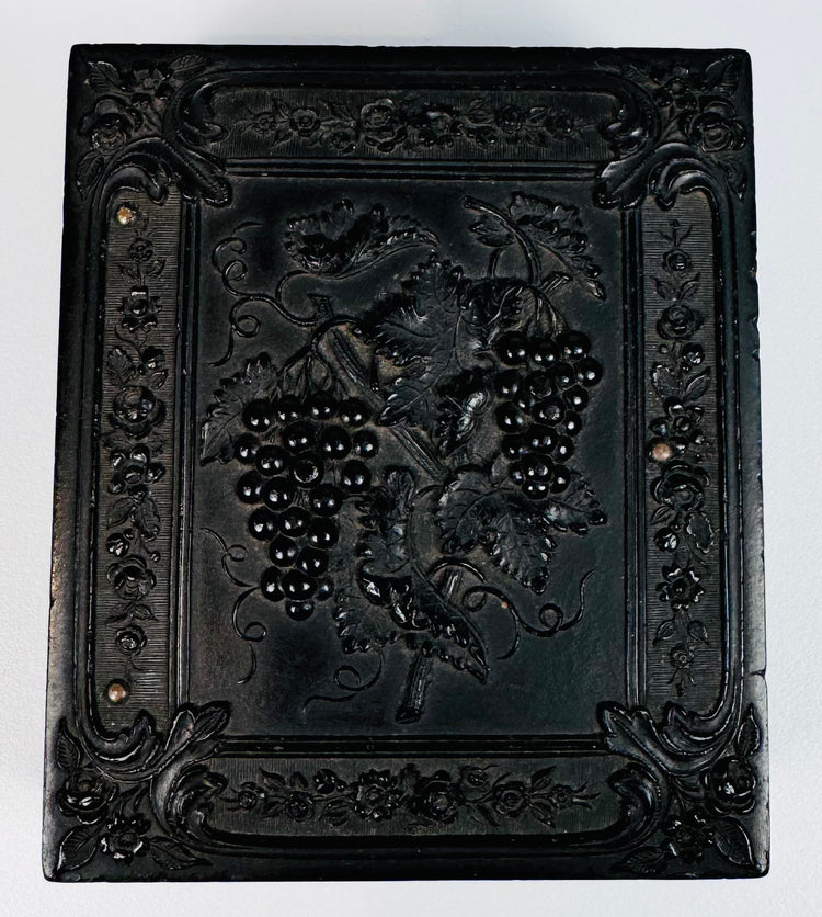 Ornately molded thermoplastic Union case with grapevine, floral, and scroll decoration