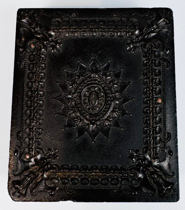Victorian Union case displaying elaborate central medallion, scrollwork, and floral relief ornament