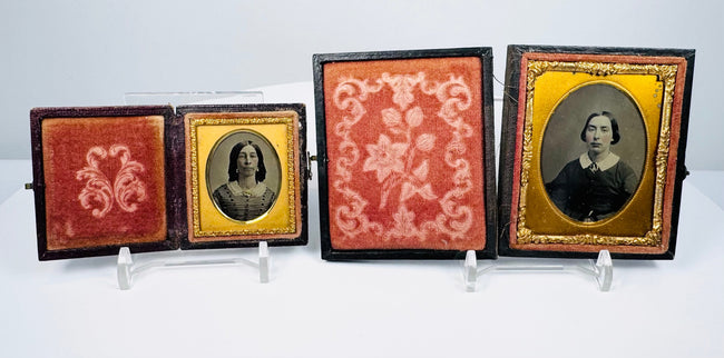 Victorian ambrotype portrait pair displayed in decorative fitted cases with embossed exteriors