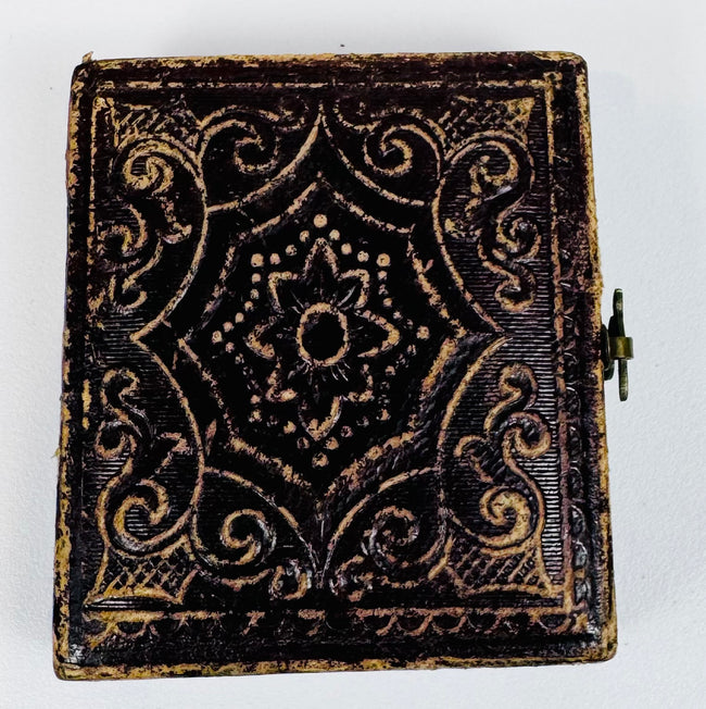 Decorative mid-19th-century photographic case with embossed scrolling and foliate exterior design
