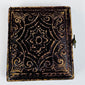 Decorative mid-19th-century photographic case with embossed scrolling and foliate exterior design