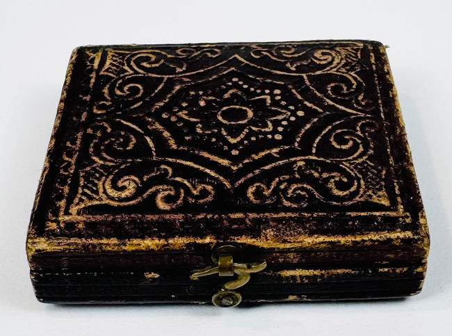 Closed Victorian photographic case with ornate embossed decoration and original metal closure hardware