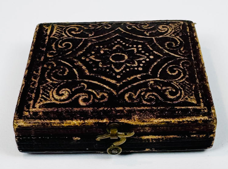 Closed Victorian photographic case with ornate embossed decoration and original metal closure hardware