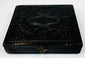Closed mid-19th-century cased photograph with molded dark exterior, ornamental design, and metal clasp
