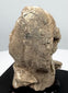 Greek terracotta protome showing heavily weathered facial features and surviving pale surface deposits