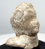 Greek terracotta protome highlighting rounded head, broad shoulder form, and archaeological surface wear
