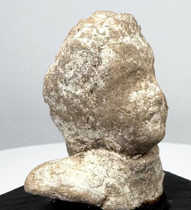 Greek terracotta protome highlighting rounded head, broad shoulder form, and archaeological surface wear