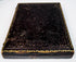 Closed mid-19th-century ambrotype case with deeply embossed floral and scroll decoration