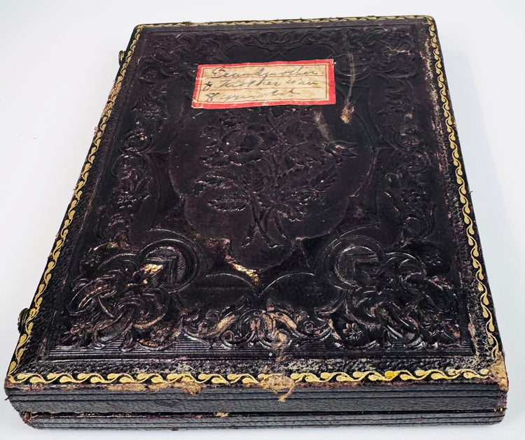 Embossed Victorian photographic case retaining handwritten family label and decorative gilt border