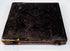 Mid-19th-century photographic case showing embossed floral ornament, worn spine, and original metal closure hardware