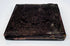 Antique cased photograph with ornate dark embossed exterior, decorative border, and age-related patina