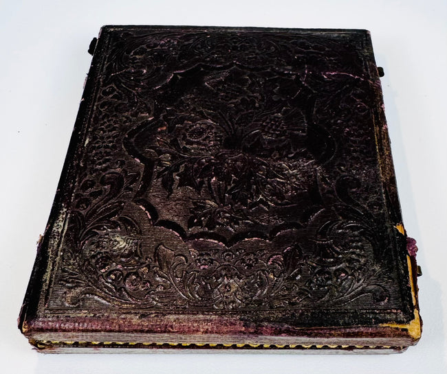 Closed Victorian photographic case with deeply embossed floral, foliate, and scrolling exterior decoration