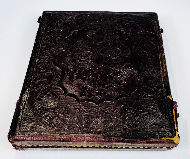 Closed Victorian photographic case with deeply embossed floral, foliate, and scrolling exterior decoration