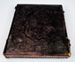 Closed Victorian photographic case with deeply embossed floral, foliate, and scrolling exterior decoration