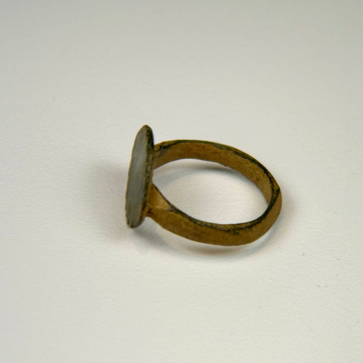 Ancient Roman finger ring displaying incised vertical lines across the bezel and centuries-old green patina
