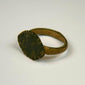 Imperial Roman bronze finger ring featuring an oval engraved bezel and natural green archaeological patina