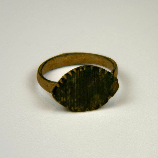 Ancient Roman bronze jewelry with oval signet-style bezel, green patination, and age-related surface wear