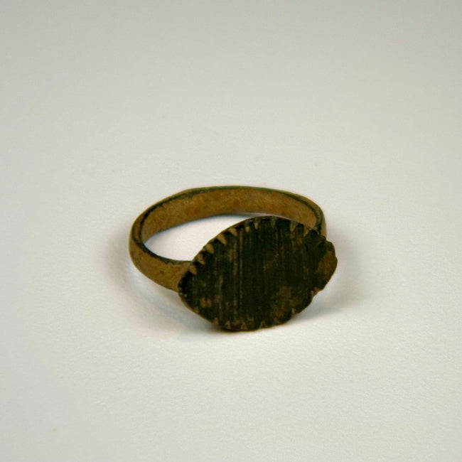 Ancient Roman bronze signet-style ring with vertical linear motifs and a solid cast circular band