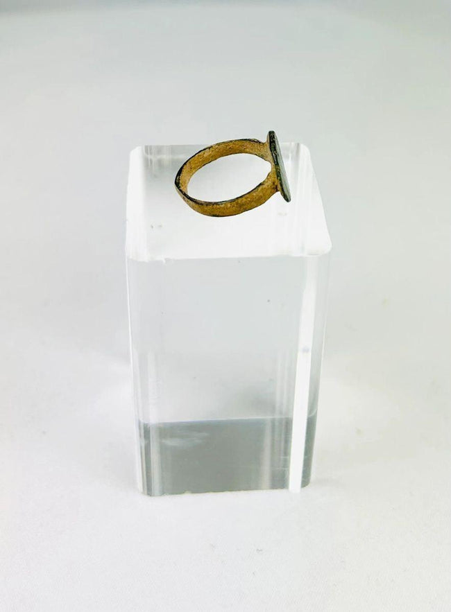 Roman bronze ring artifact photographed to show texture and incised decoration