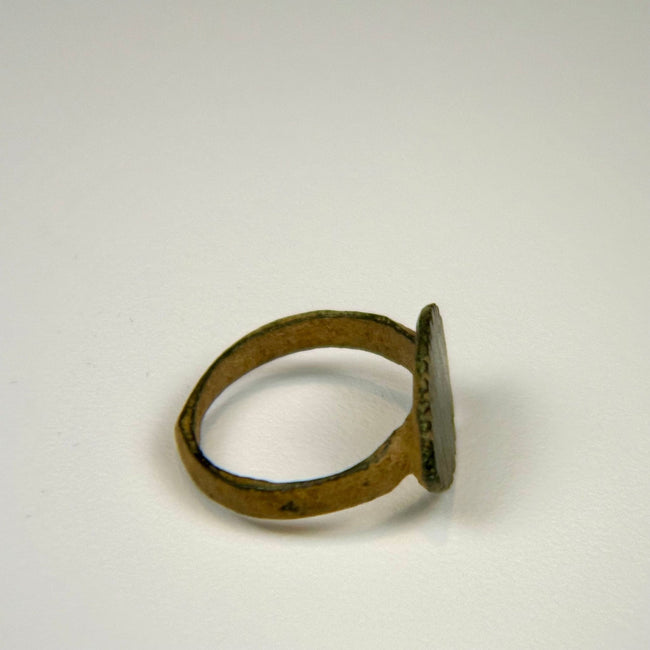 Ancient Roman signet ring with raised oval bezel and preserved vertical engraved detailing