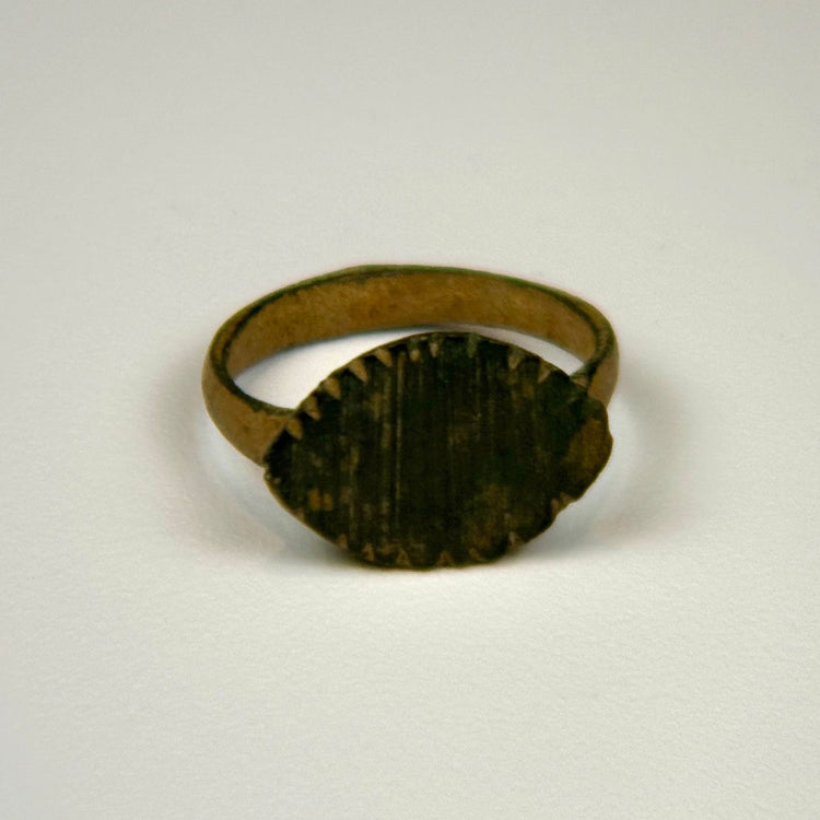 Roman bronze ring dating circa 100–300 CE with vertical bezel engraving and preserved archaeological character