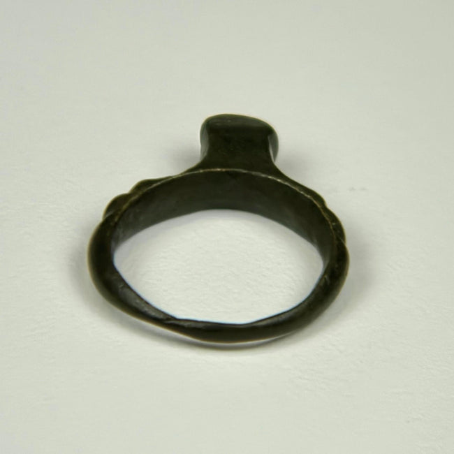 Ancient Roman jewelry ring with flat bezel, subtle surface oxidation, and preserved cast construction