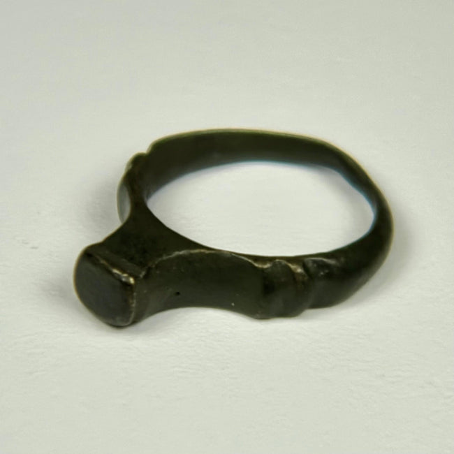 Ancient Roman finger ring with broad bezel, compact band, and preserved archaeological character