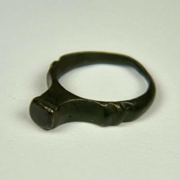Ancient Roman finger ring with broad bezel, compact band, and preserved archaeological character