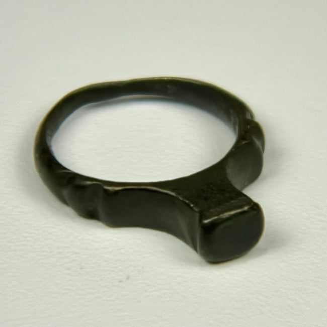 Ancient Roman bronze ring with smooth signet face, rounded shank, and deep green patina