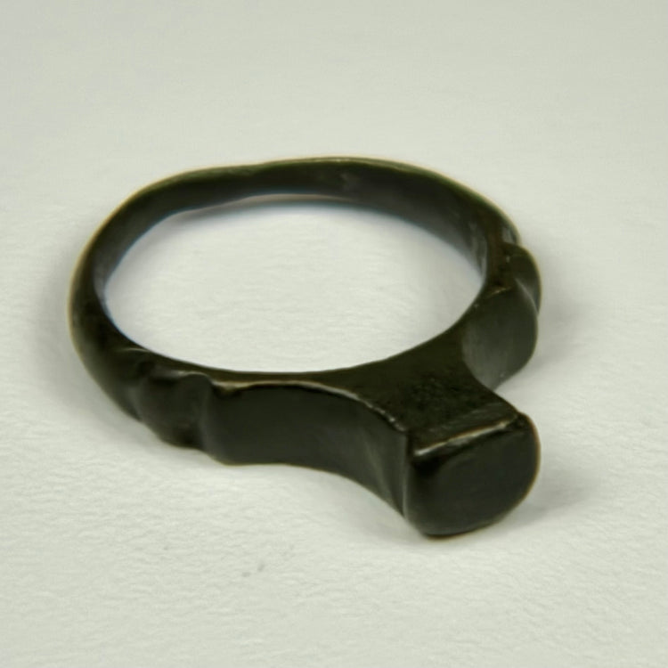 Ancient Roman bronze ring with smooth signet face, rounded shank, and deep green patina