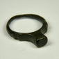 Ancient Roman bronze ring with smooth signet face, rounded shank, and deep green patina