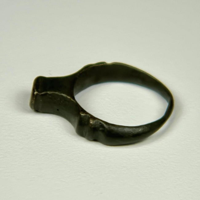 Roman bronze signet ring dating circa 100–300 CE with worn bezel and natural green-black patina