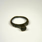 Imperial Roman bronze finger ring featuring a smooth worn bezel and rounded cast band