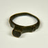 Ancient Roman signet ring with flat raised bezel, archaeological patina, and light earthen encrustation